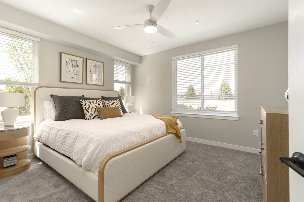 a bedroom with a bed and a ceiling fan